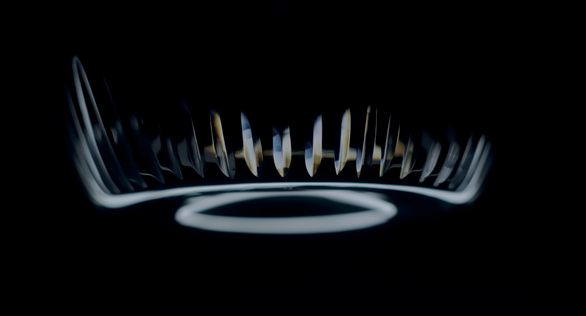 Solitaire ring reflected in soft light on black
