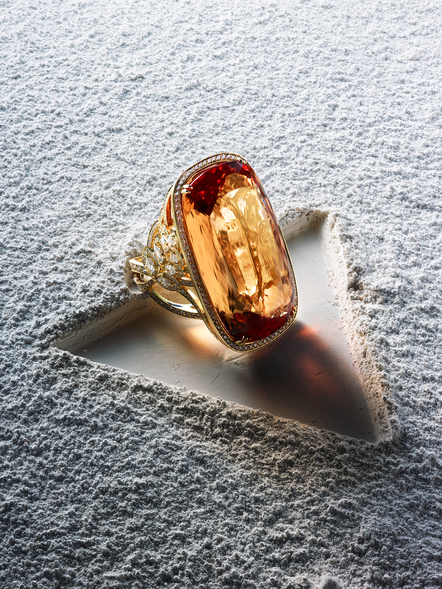 Ring on stone, hard shadow travelling into open negative space